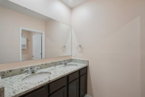 Upstairs full bathroom with dual sinks and shower