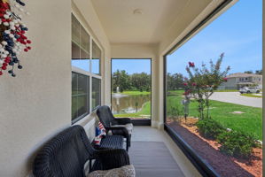 Relax on your screened front porch beside the pond