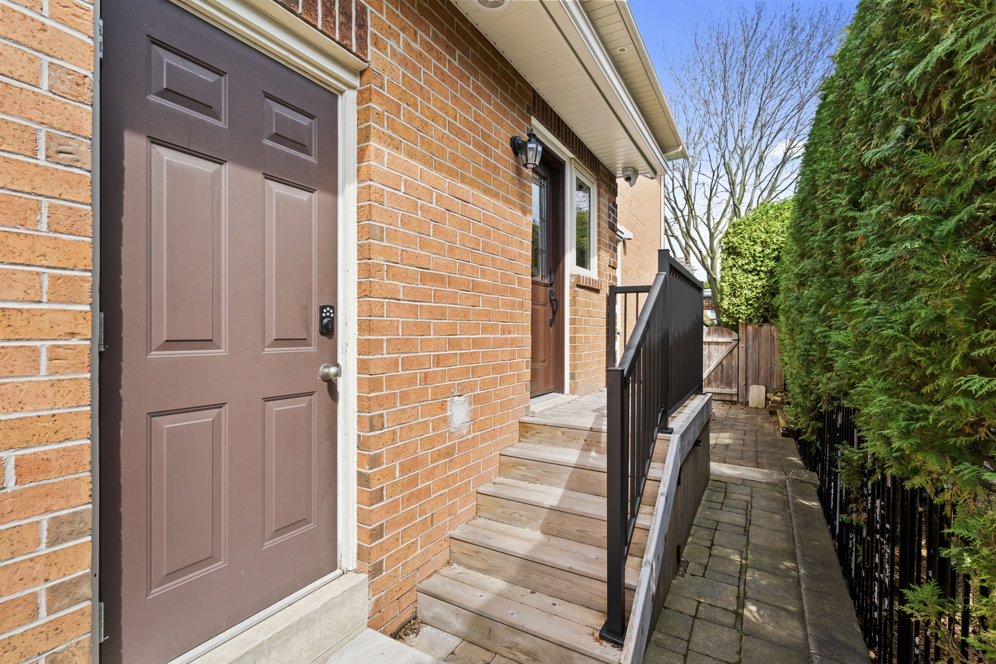 Exterior side entrance to garage + stairs to studio apartment entrance