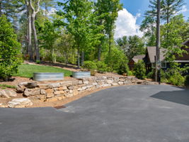 Front stone retaining wall, great area for growing in raised beds