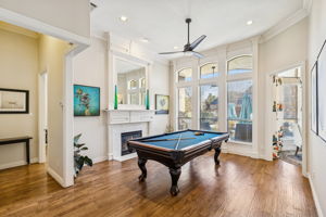 Formal sitting area with fireplace and views of serene backyard
