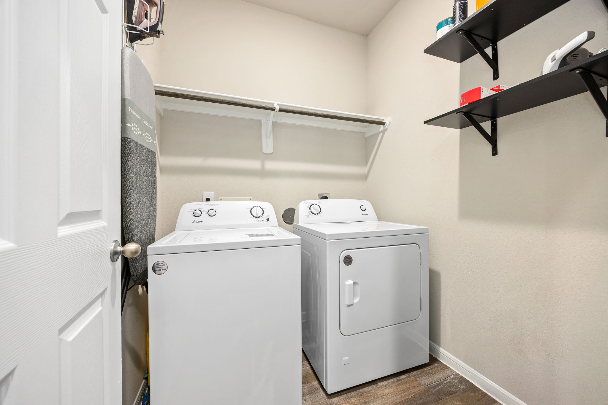 Laundry room with full size washer and dryer connections and storage shelves