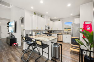 Kitchen with shaker cabinets and stylish gold drawer and door pulls.