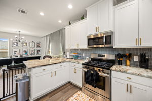 Kitchen open to dining room with recessed lighting