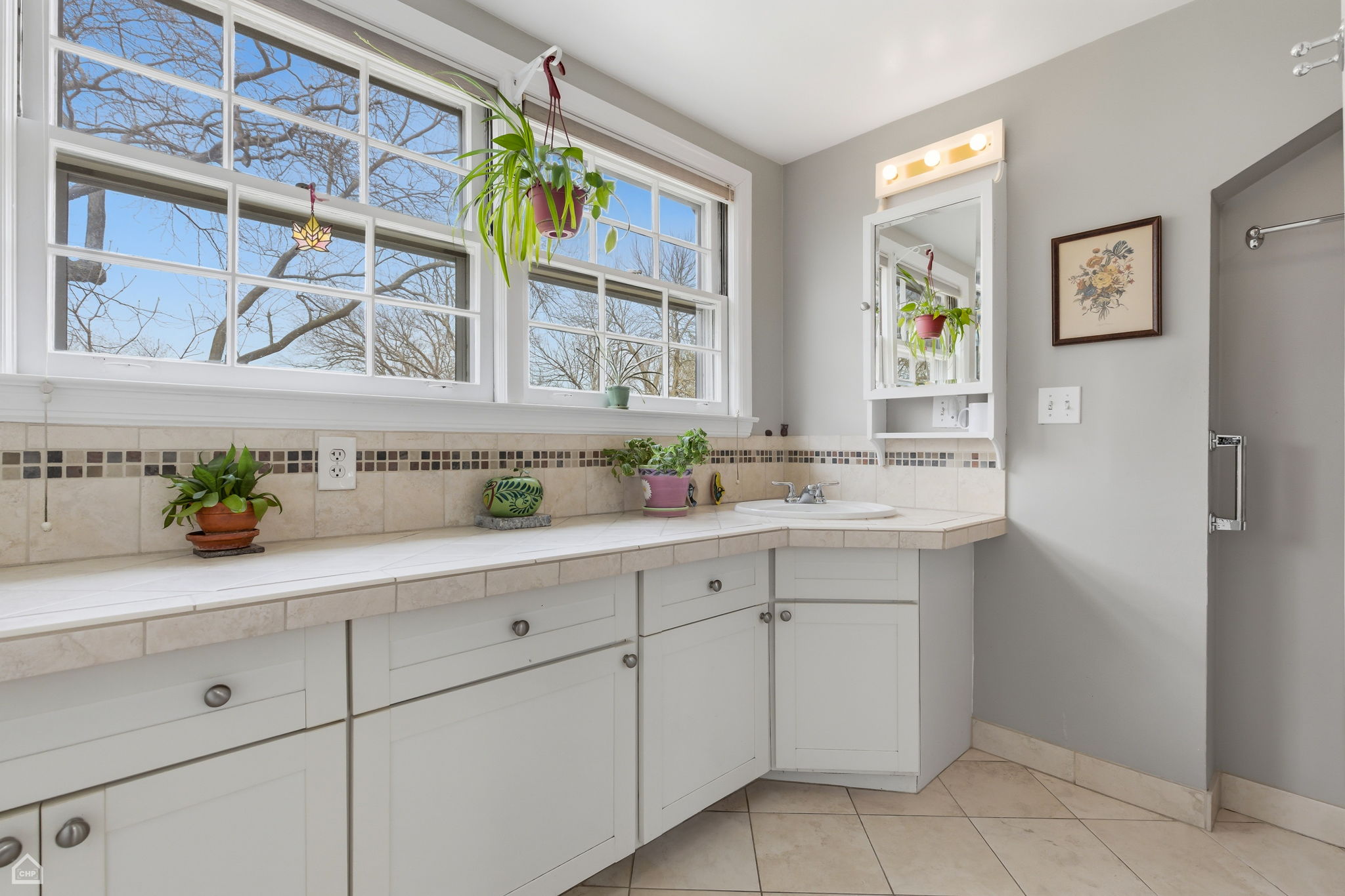 Master bath features tiled extra-long vanity and standing walk-in shower.