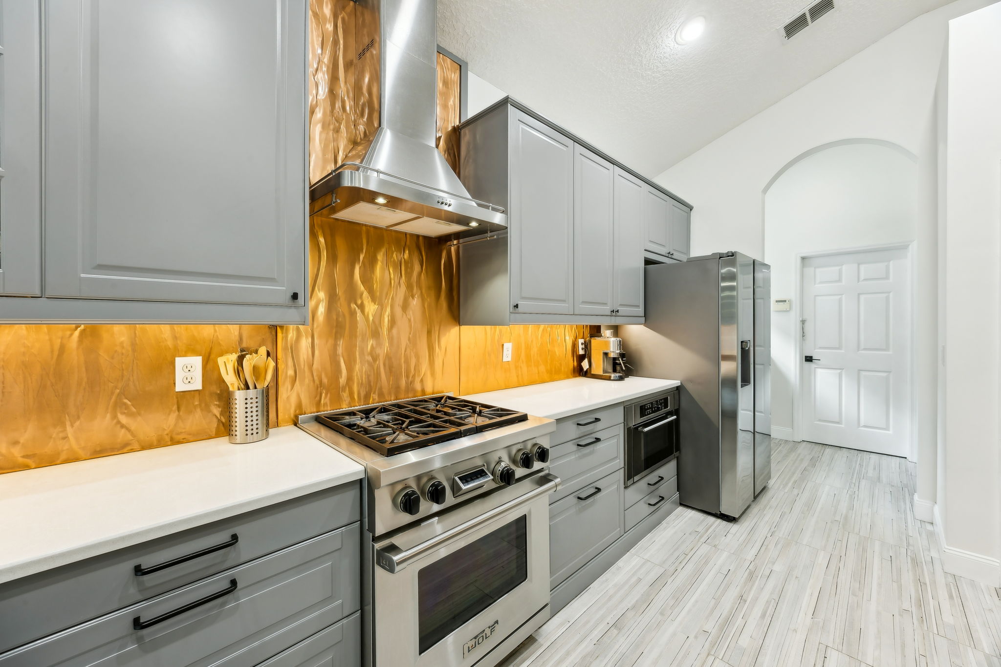 Wolf range, under counter microwave and custom cabinets.