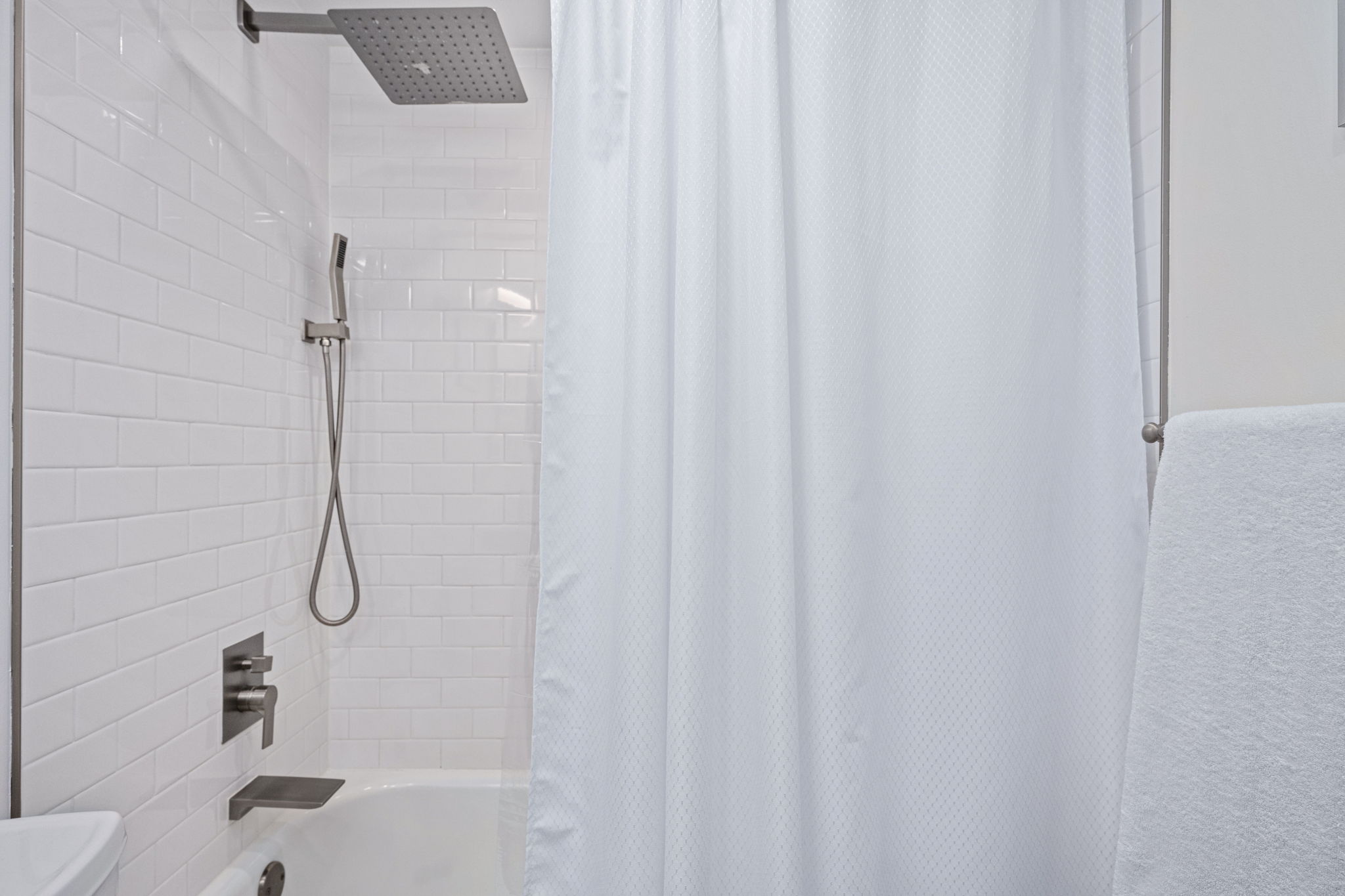 Bright, white tile and modern fixtures