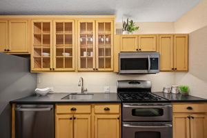 Kitchen boasts glass front cabinets