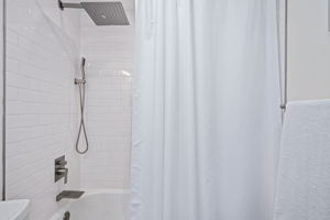 Bright, white tile and modern fixtures