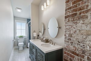 First stop is the guest full bath with more of those vintage brick accents...