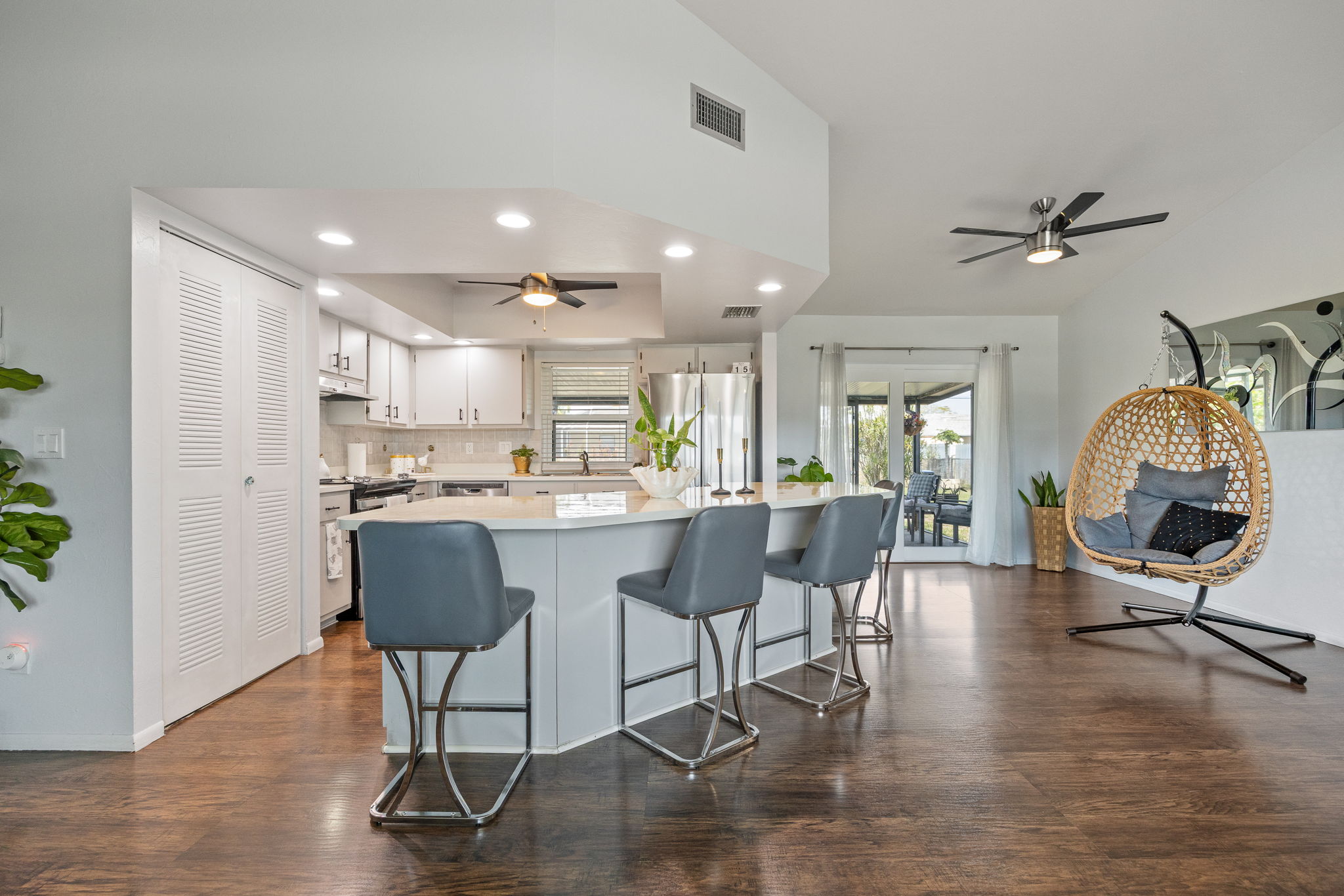 Open kitchen layout with Impact Resistant Pocket Sliding Glass Door for seamless indoor-outdoor living.