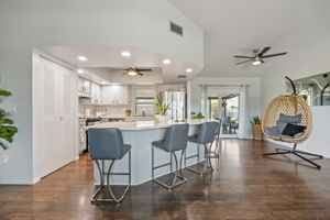 Open kitchen layout with Impact Resistant Pocket Sliding Glass Door for seamless indoor-outdoor living.