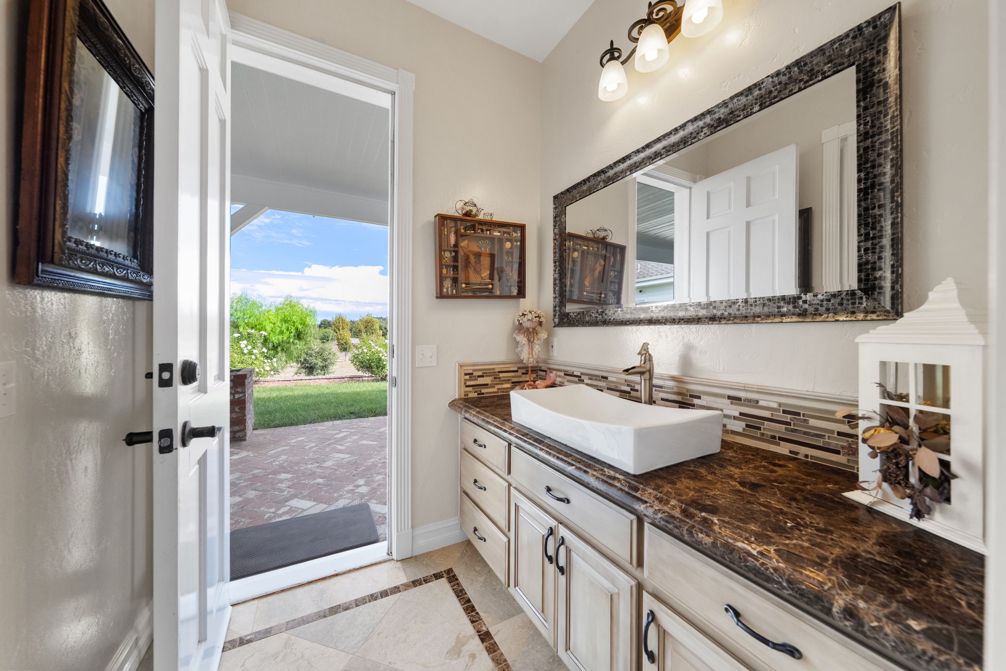Secondary shared bath with sink opens to back yard