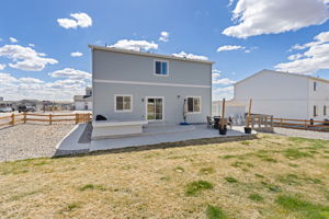 Expansive back patio with built-in table, perfect for BBQs and entertaining!