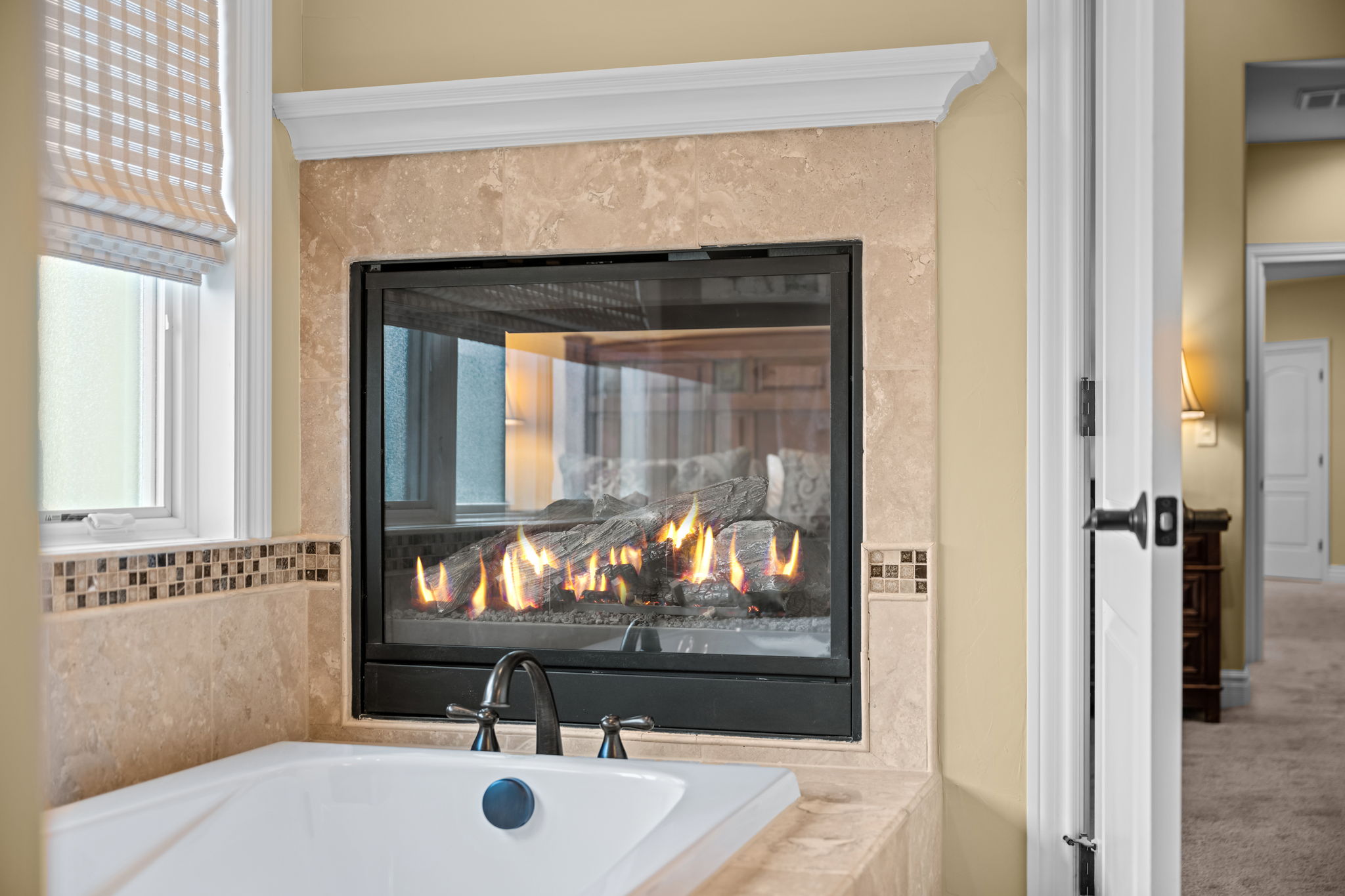 Luxurious, spa-like atmosphere in a primary suite, allowing for shared warmth and ambiance