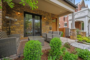 Covered front patio designed for indoor-outdoor entertaining for year-round enjoyment