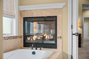 Luxurious, spa-like atmosphere in a primary suite, allowing for shared warmth and ambiance