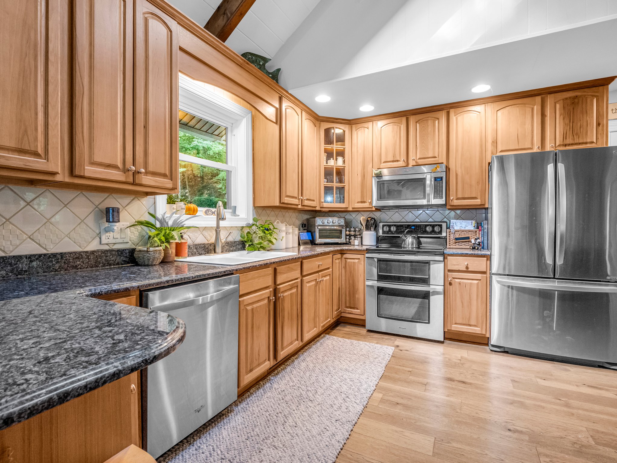 Kitchen boasts granite countertops, ample cabinet space for storage, and stainless steel appliances.