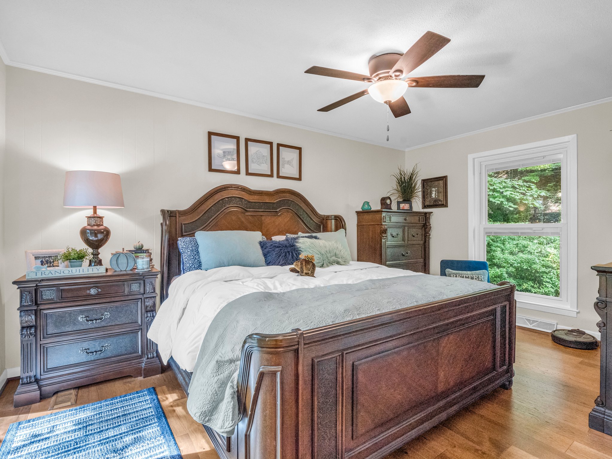 One of two guest bedrooms on the main level, features access to the wrap-around back deck overlooking the lake.