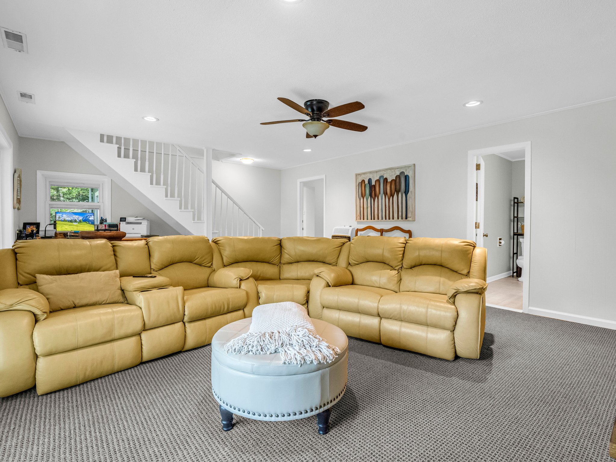 Family room in the finished basement with guest bath, laundry room, ample storage, and guest bonus room.