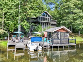 Rarely available lakefront home with no steps from your driveway & garage into the home, and minimal steps from the house to the lake & dock!