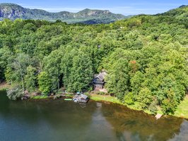 Private setting on Bald Mountain Lake, is just a short walk to hiking trails, and a golf cart ride inside the gates to the resort amenities of Rumbling Bald on Lake Lure.