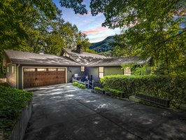 Circular driveway with drive-through garage offers level, easy access into the lakefront home.