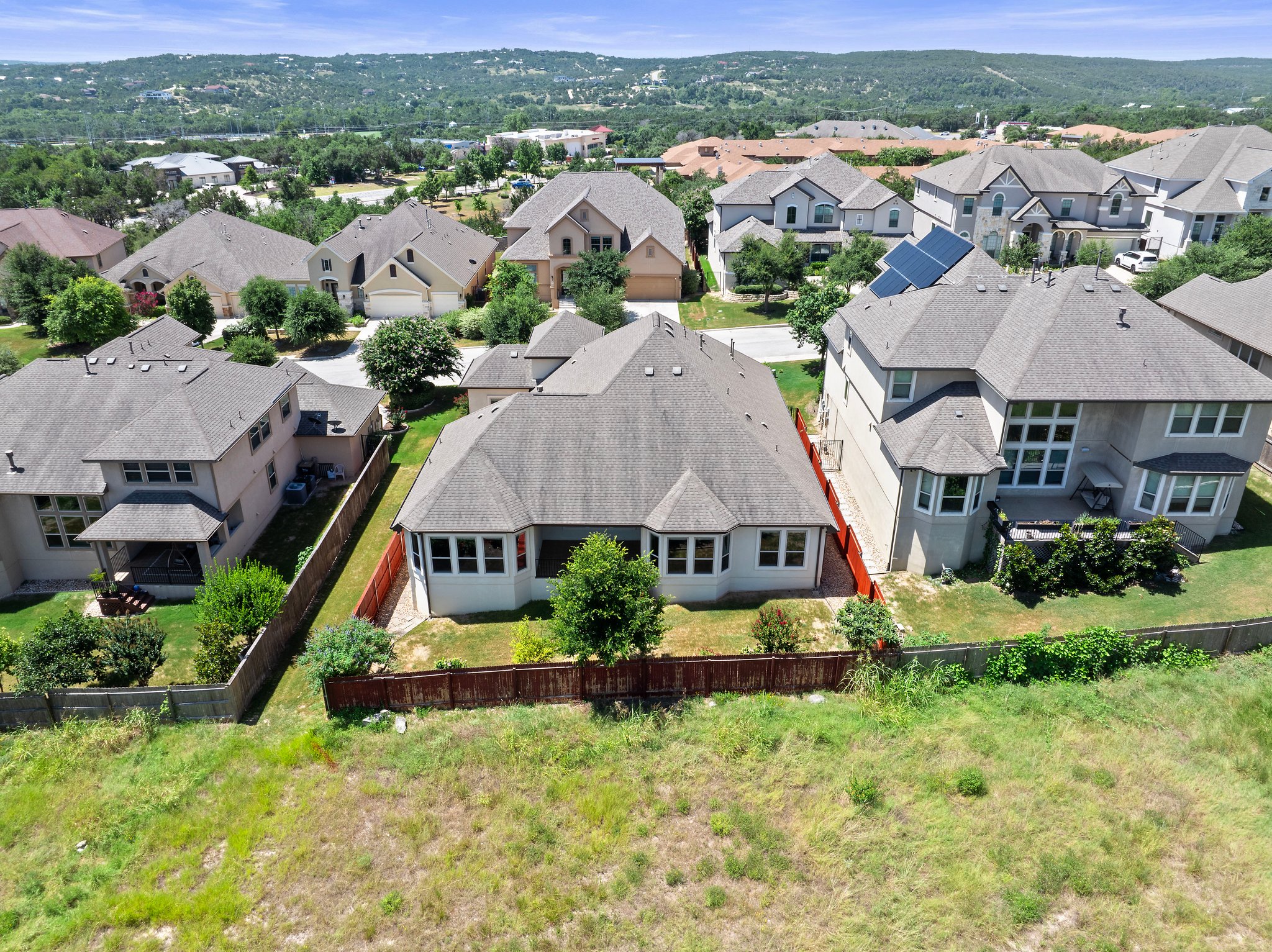 The home backs to an open green space.