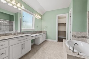 The primary bathroom has two sinks, soaking tub, large walk-in shower and spacious closet.