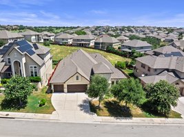 Large driveway. The home backs to an open green space.