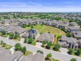 The home backs to an open green space.