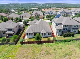 The home backs to an open green space.