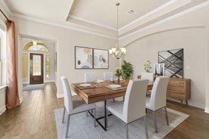 Spacious dining area near the living room and front door. Virtually staged.