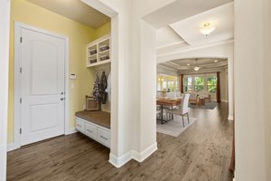 As you walk in the front door, you'll be greeted to a wall of windows. The garage and mudroom are to the left.