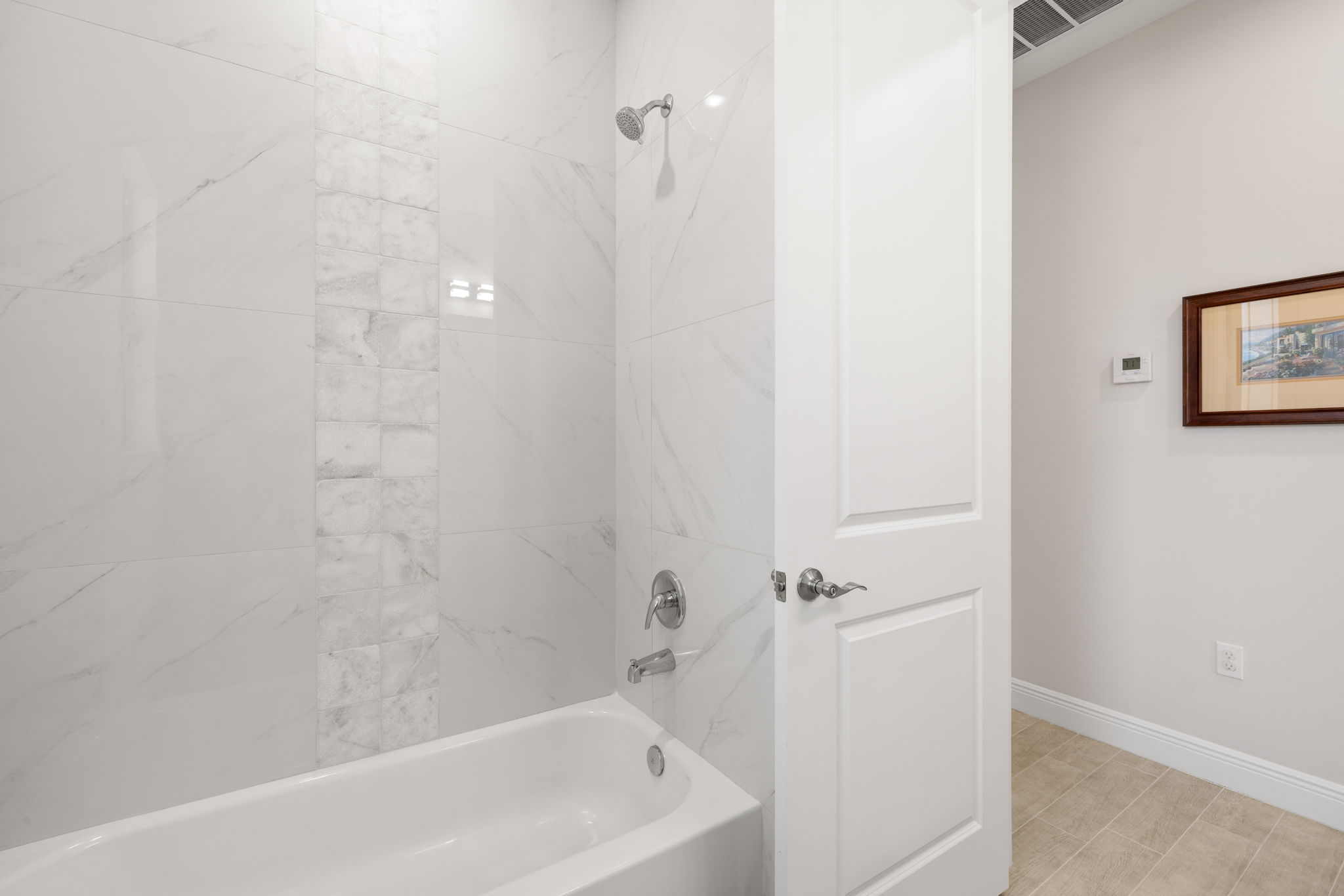 Guest bath with tile to the high ceiling.