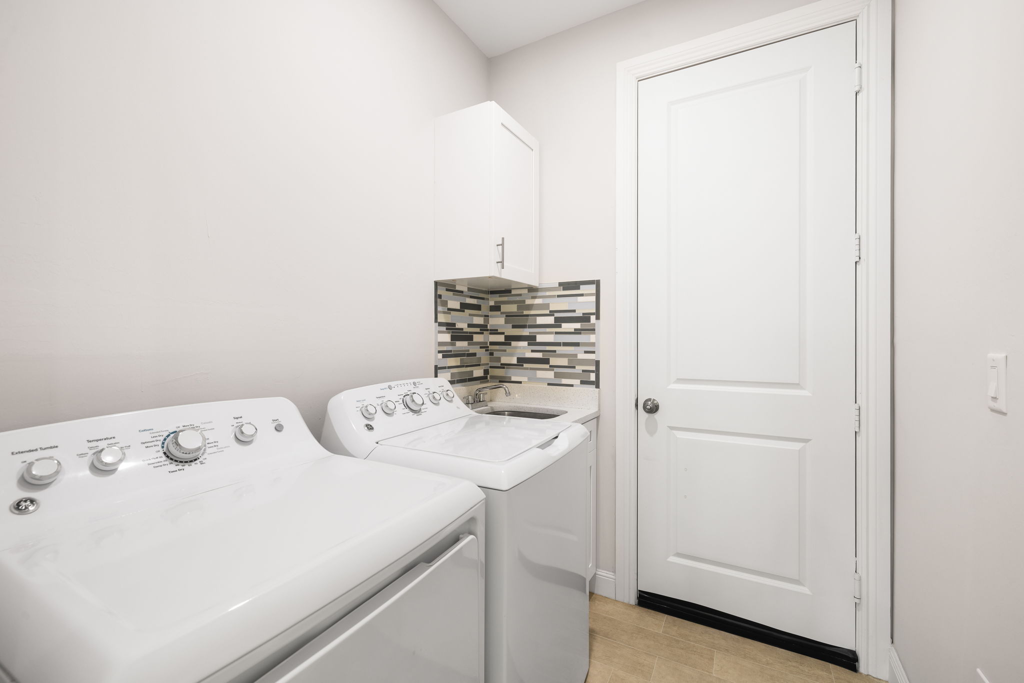 Generous laundry room with laundry tub.