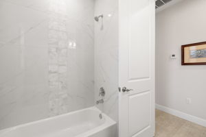 Guest bath with tile to the high ceiling.