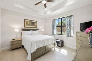 Master suite with views of a landscaped, wooded area.