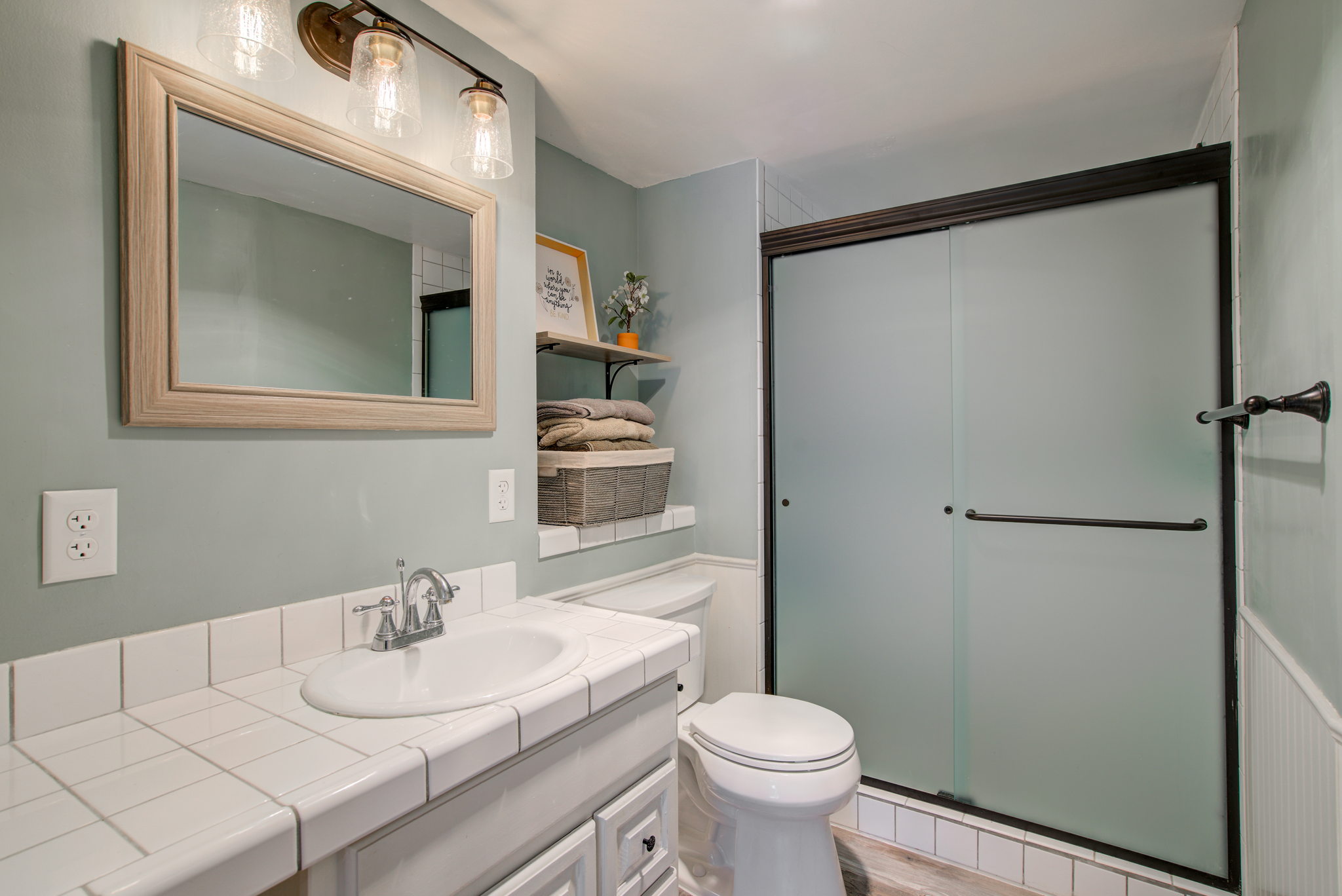 The lower level 3/4 bathroom features an updated shower and luxury vinyl flooring.