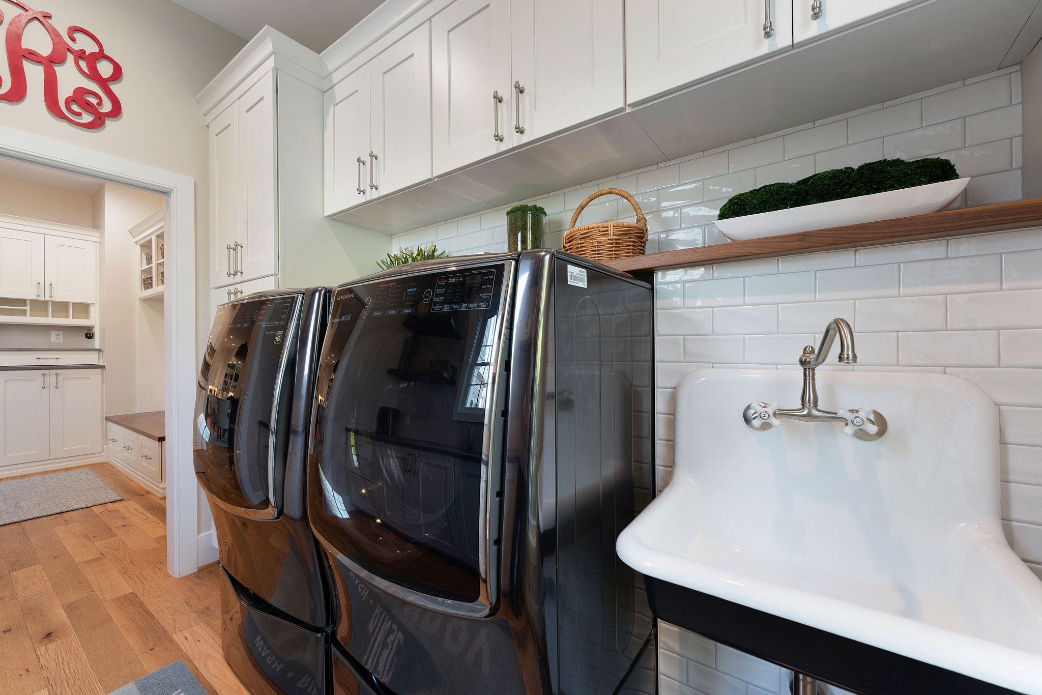 A farm sink blends with an updated laundry center