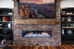 The hand crafted wood mantle and brick facade make this gas fireplace stunning