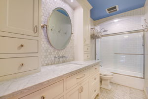 Upper level full bathroom with marble countertops