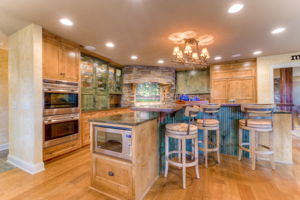 Gourmet chef's kitchen features Wolf appliances, honed granite counters, knotty alder cabinets & separate butler's pantry