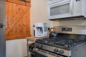Hidden pantry behind barn door cupboards