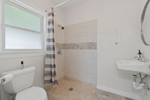 ADA compliant bathroom boasts a shower & privacy window.