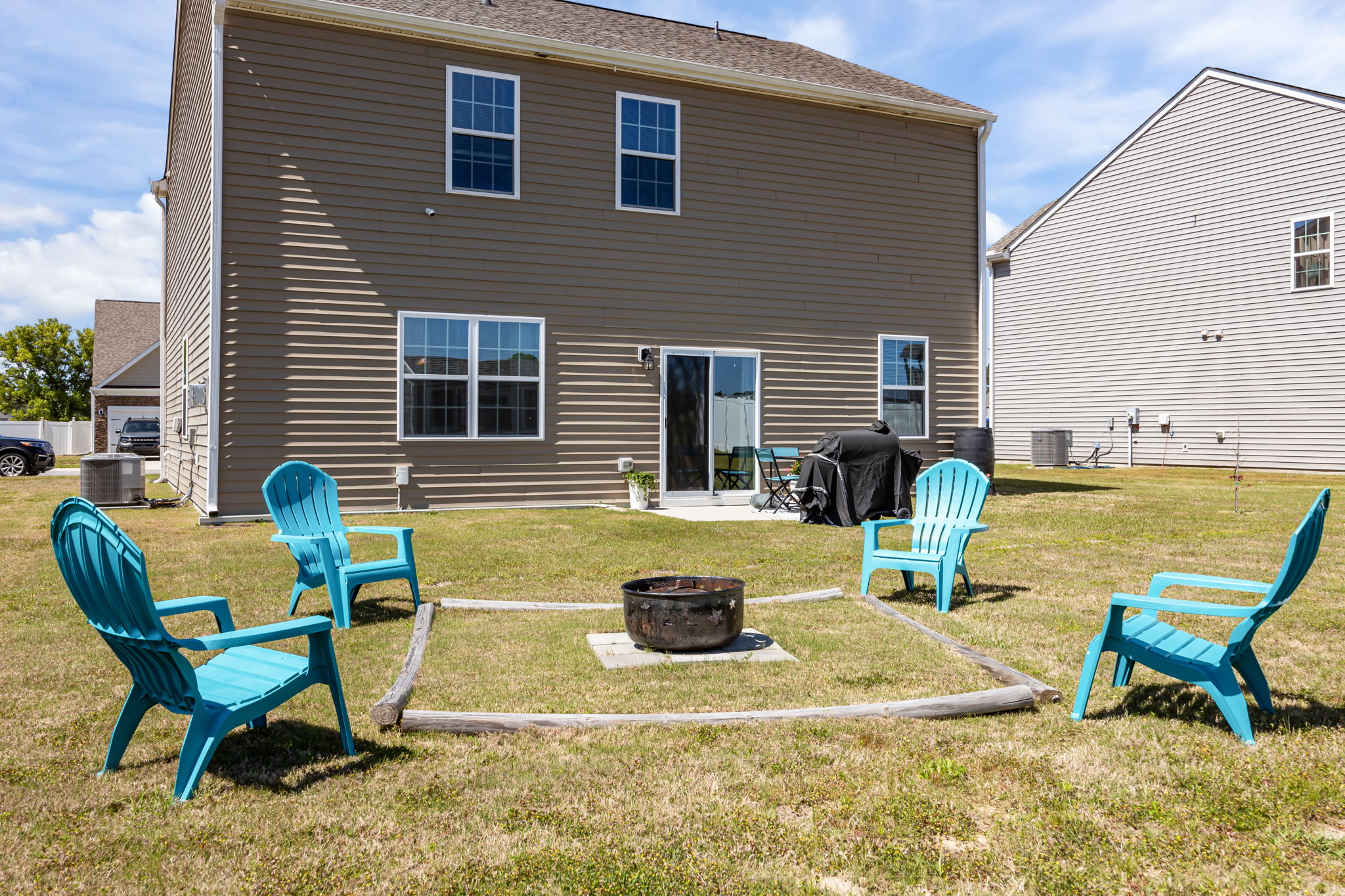 Backyard w/ an Open Patio and Fire Pit