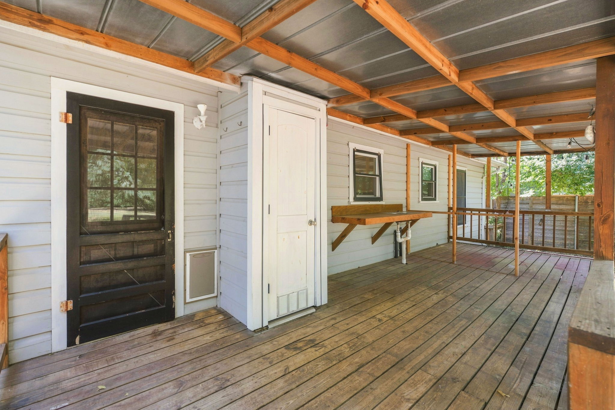 Back porch was added by prior owners.  The closet seen holds the tankless water heater.