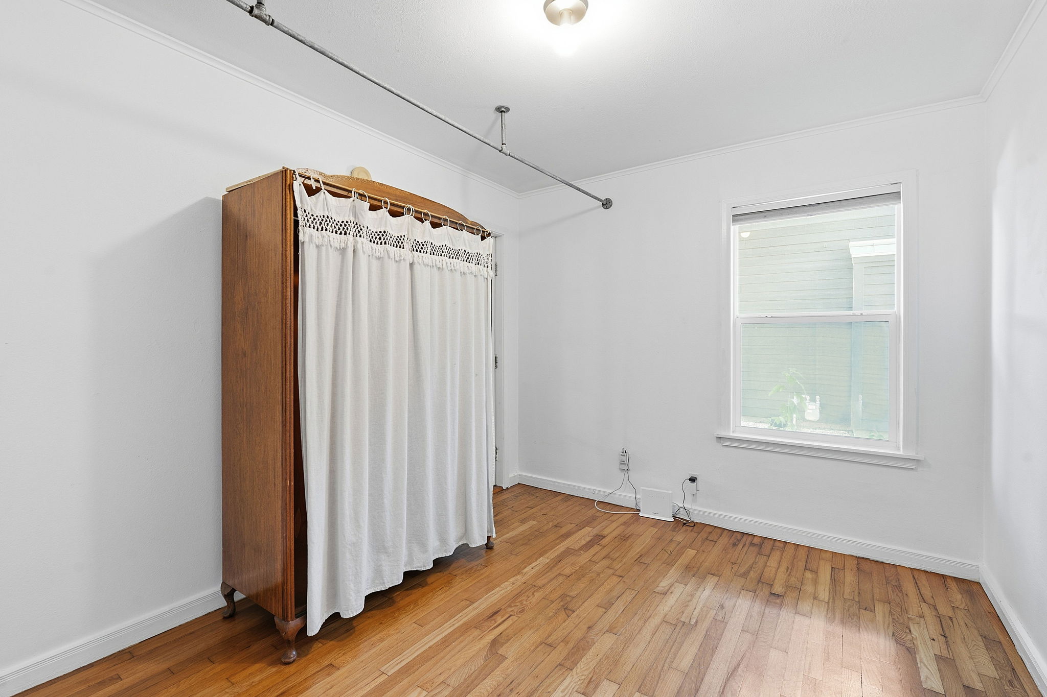 The second bedroom uses an armoire as a closet (the closet was removed).