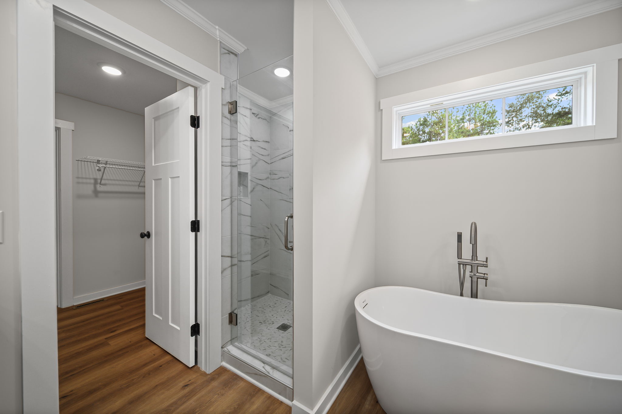 Primary bathroom with soaking tub and separate stand up tiled shower