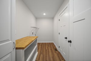 Adequate laundry room with folding table and cabinet